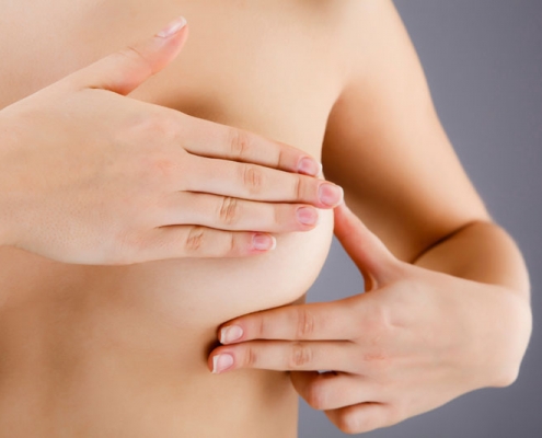 Woman examining her breast