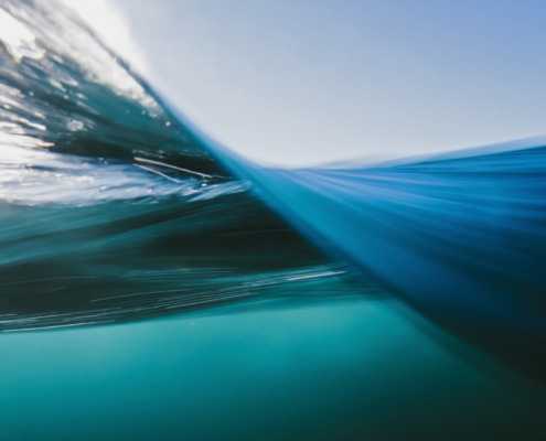 Split-Ansicht des blauen Ozeanwassers unter und über der Wasseroberfläche